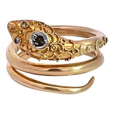 This snake ring is set in 14K Yellow Gold and is a size 6-6.5 and weighs 8.44 grams.  This snake is simple but it has an incredible detailed head and part of the body is granulated.  Granulation means the placing of small bits of gold to create a scroll type effect.  This also has two tiny Diamond eyes and a Diamond Head of .20 carats. As many of you know I love snakes, rings, bracelets, pendants etc, this is no different.  I purchased this out of the United Kingdom a few weeks ago and it is ready for its new owner.  This is a bit more than simple but it is not that big or expensive so do not wait. Diamond Head, Ruby Diamond Rings, Snake Jewelry, Snake Bracelet, Diamond Eyes, Tiny Diamond, Snake Ring, Gold Snake, Rings Bracelets