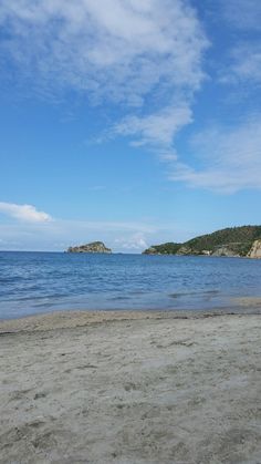 an empty beach on a sunny day with blue skies