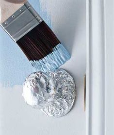 a paintbrush is being used to paint a white wall with blue and gray colors