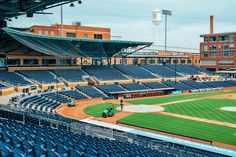 an empty baseball stadium filled with blue seats