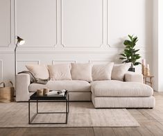 a living room with a white couch and coffee table on the floor next to it