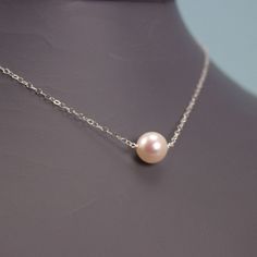 What can be more simple and classy than this necklace?   You can wear it all the time with everything!  Beautiful, round 8mm white/ivory Freshwater Pearl on sterling silver chain.   Necklace shown on the model measures 15.5 inch  I can make this necklace in sterling silver, gold filled, ROSE gold filled or 14k solid gold  Available also with 8mm Swarovski pearl for a lower price  Cultured freshwater pearls are pearls that are farmed and created using freshwater mussels.   Those pearl are much mo Delicate Cream Jewelry For Formal Occasions, Cream Pearl Pendant Necklace, Delicate Round Pearl Necklace, Classic Pearl Necklace With Round Pendant For Wedding, Delicate Pearl White Sterling Silver Necklace, Elegant Cream Necklaces With Pearl Charm, Elegant Cream Necklace With Pearl Charm, Elegant Cream Jewelry With Pearl Pendant, Delicate Sterling Silver Pearl Necklace With Round Shape