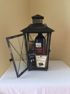 a bottle of wine sitting on top of a table next to a candle holder and mirror