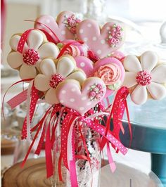 a vase filled with lots of cookies on top of a table