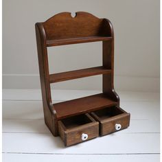 a wooden shelf with two drawers on it