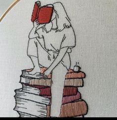 a woman sitting on top of a stack of books with a book in her hand