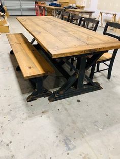 a wooden table with benches in a warehouse