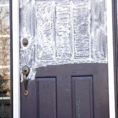 the front door is covered in ice and frosty paint, with an iron handle on it