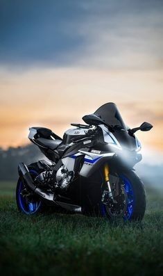 a motorcycle parked in the grass on a cloudy day