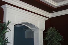 a potted plant sitting on top of a wooden shelf next to a doorway in a building