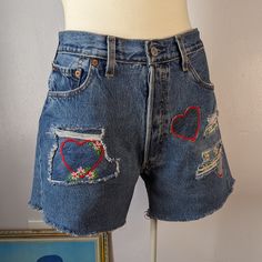 "shipping will be delayed on this item- it will be available to ship after 8/18/23 Reworked Upcycled Vintage Levi's 501 Cut Off Shorts by Sensible Slacks. This is a one of a kind reworked pair of Levi's, upcycled with hand made and embroidered heart and flower patches. These had large holes throughout and a piece missing from the back waistband- I repaired the damage with handmade and embroidered patches. Button fly. Medium wash. Marked size W 33. Measures 32\" waist, 11.5\" rise, 43\" hips, 4.5 Diy Jean Shorts, Vintage Levi Shorts, Denim Embroidery, Patchwork Heart, Brunch Fashion, Flower Shorts, Vintage Levis Jeans, Flower Vintage, Embroidered Heart