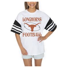 Showcase your Texas Longhorns pride in style with the Gameday Couture Starting Lineup Contrast Sporty Heritage Oversized T-Shirt. The oversized fit provides a trendy and relaxed look, making it perfect for game day or any casual occasion. Made from 100% cotton, this tee offers exceptional comfort and breathability, ensuring you stay cool and confident while cheering on the Texas Longhorns. White Oversized Top For Game Day, Oversized Fan Apparel Tops For Game Day, White Oversized Tops For School Spirit, Oversized T-shirt For Game Day In Fall, Oversized Varsity Tops For Sports Season, White Varsity T-shirt For Fall, Oversized Varsity T-shirt For Fall, Oversized Letter Print Tops For Game Day, Oversized White T-shirt For Sports Season