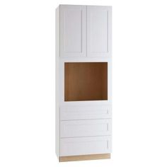 a white cabinet with wooden doors and drawers on the bottom, in front of a white wall