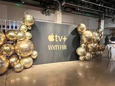 an apple tv and vanity fair event with gold balloons