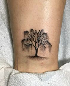 a small tree tattoo on the ankle