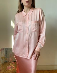 Beautiful Italian vintage pink blouse made out of gorgeous charmeuse silk blouse with a satin shine to it. Truly pretty.  tag size: 40, best fits xs - s, might fit m, however, please see measurements  circa: 90s  overall in great condition, no major flaws, has a very light mark at the front  MEASUREMENTS *taken seam to seam. not doubled, taken flat Shoulders: 38 cm | 14.9" Bust: 49 cm | 19.2" Sleeve length: 57.5 cm | 22.6" Length: 62 cm | 24.4" For reference, our model is size S and is 5"2 tall Pink Satin Feminine Blouse, Pink Satin Blouse In Feminine Style, Pink Satin Top For Work, Pink Silk Button-up Blouse, Pink Silk Button-up Top, Long Sleeve Pink Satin Top, Pink Long Sleeve Satin Top, Pink Satin Long Sleeve Tops, Silk Pink Top For Workwear