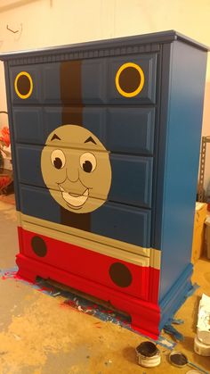 a thomas the tank engine dresser painted in blue and red with black dots on it