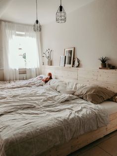 two beds in a bedroom with white sheets and pillows