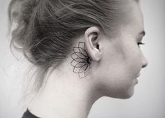 a woman with a flower tattoo on her ear