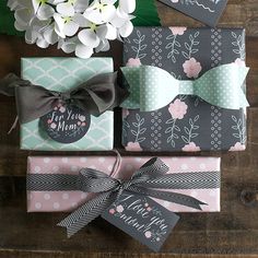 some cards and flowers are sitting on a wooden table with the words happy mother's day written on them