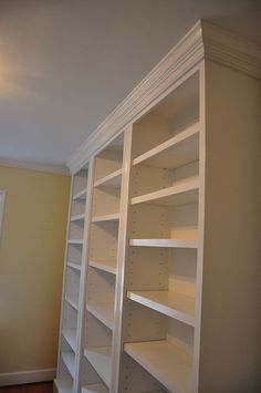 an empty white book shelf in a room