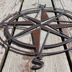 a metal pentagram sitting on top of a wooden bench