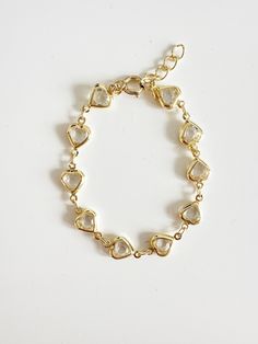 Perfect worn on its own or layered with our other bracelets. *18k gold plated, e-coated (a special coating to not tarnish easily) *E-coated jewelry is hypoallergenic, tarnish resistant *Clear cubic zirconia *Avoid contact with harsh chemicals, perfumes, water, etc. Available in 6"-8" length If you need a custom length, please message me.  Ready to ship Gold Dainty Crystal Bracelet With Adjustable Chain, Gold Crystal Bracelet With Adjustable Chain, Dainty Style, Dainty Gold Crystal Bracelet With Adjustable Chain, Gold Heart-shaped Crystal Bracelet Gift, Delicate Gold Crystal Bracelet, Valentine's Day Gold Crystal Bracelet With Heart Charm, Elegant Gold Charm Bracelet With Heart Beads, Gold Heart Beads Bracelets For Wedding, Gold Heart Beaded Bracelets For Wedding