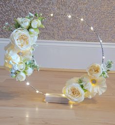 a wreath with flowers and lights on the floor