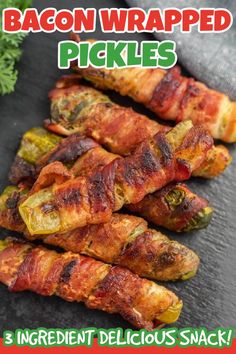 bacon wrapped pickles on a black plate with parsley in the background and text overlay