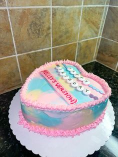 a birthday cake sitting on top of a counter next to a tile backsplash