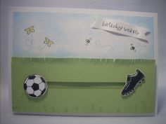 a birthday card with soccer shoes and a ball on the grass next to a butterfly