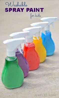 spray bottles filled with different colors of paint on the sand and text overlay that says washable spray paint for kids