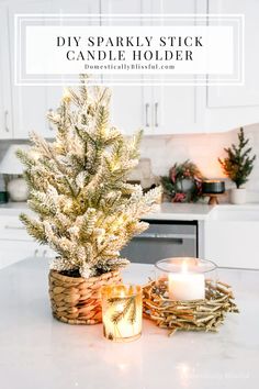 a small christmas tree sitting on top of a kitchen counter next to a lit candle