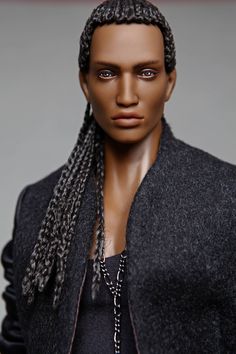 a close up of a doll with braids on her head