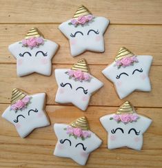 decorated cookies in the shape of stars and unicorn faces