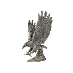 an eagle figurine is shown with its wings spread and taloning it's claws