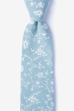 a light blue tie with white flowers and leaves on the end, against a white background