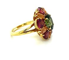 This happy ring made from a kaleidoscope of gems is sure to make you smile! A vivid green tourmaline oval is encircled by rounded pear-shaped garnets and marquise shaped precious topazes in a unique combination of gemstone colors and shapes that will be your "go to" ring for fall, or anytime you want to lift your spirits! Handmade in 18k yellow gold by our jewelers in Los Angeles. Green tourmaline, 10.05 x 8.11mm, 2.92 carats Rounded pear shaped garnets, 6.00 x 6.00mm, 4.29 carat total Marquise Multicolor Multi-stone Emerald Oval Ring, Yellow Gold Tourmaline Jewelry With Gemstone Accents, Multicolor Oval Tourmaline Rings, Oval Multicolor Tourmaline Rings, Multicolor Tourmaline Gemstones Fine Jewelry, Yellow Gold Citrine Gemstones With Multi-stone Detail, Yellow Gold Tourmaline Multi-stone Jewelry, Orange Multi-stone Fine Jewelry Rings, Topaz Yellow