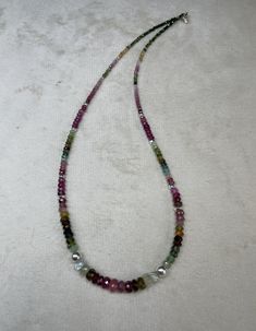 Traditionally, tourmaline is considered a symbol of youth, kindness, love and faith.  The many-sided mineral also symbolizes creativity, flight of thought and imagination, the ability to see magic in ordinary things or create magic out of everyday life.. Made with silver clasps and beads Round Tourmaline Necklace With Natural Stones, Tourmaline Gemstone Beads Necklaces, Healing Tourmaline Gemstone Bead Necklaces, Faceted Tourmaline Necklace Perfect As A Gift, Spiritual Tourmaline Gemstone Bead Necklaces, Adjustable Tourmaline Gemstone Necklace, Healing Tourmaline Gemstone Necklace, Spiritual Tourmaline Gemstone Beads Jewelry, Spiritual Tourmaline Gemstone Bead Necklace