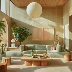 a living room filled with lots of furniture next to a large potted plant on top of a wooden table