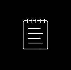 a black and white photo of a notepad with lines on the front, in a dark background