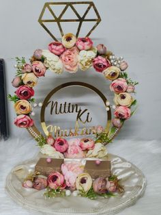 a cake topper with flowers on it and the words nutty k muskkin