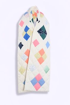 a white quilted jacket with colorful squares on it