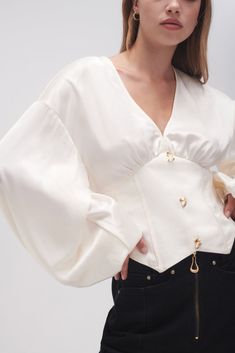 PRODUCT DETAILS Women’s blouse Deep V-neckline Corseted waist panels Full, gathered blouson sleeves Non-functional buttons Angled hemline Shop All Tops SIZE AND FIT Model wears a size 8/S Model: 176cm/5’9.5" Bust: 80cm Waist: 58cm Hips: 88cm FABRICATION 81.5% Acetate 18.5% Polyester Lining: 100% Cotton Delicate Cold Hand Wash Seperately Victorian Blouse, Straykids Hyunjin Photoshoot, Modern Victorian, Fashion Design Portfolio, Fashion Mistakes, Blouse Online, Style Mistakes, 10 Pounds, Coconut Cream