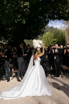 a bride and groom walking down the aisle