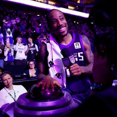 a man holding a basketball in front of a crowd