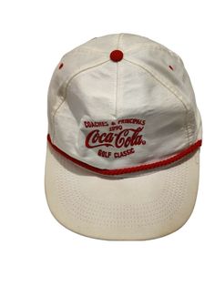 Vintage Gulf Coast Specialty 1990 CocaCola Golf Classic Hat Coaches & Principals Beige/Red Adjustable. Condition is Pre-Owned. Interior has a bit of damage. Ships via USPS First Class Mail. Vintage Snapback, Classic Hats, Red One, Gulf Coast, Snapback Hats, Coca Cola, Coaching, Baseball Hats, Golf