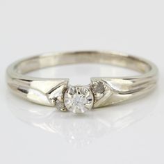 a white gold ring with three diamonds on it