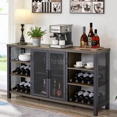 a buffet table with wine bottles and cups on it in front of a window filled with pictures