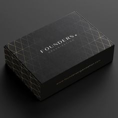 a black box with the word founders printed on it and gold foiling around the edges